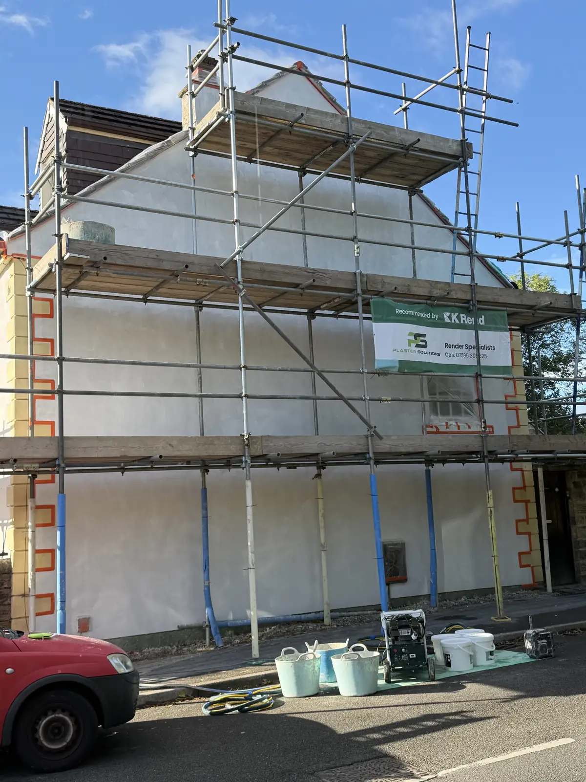 The same Sheffield property scaffolded, with a reinforcing base coat applied over the pebbledash and the stone quoins masked off