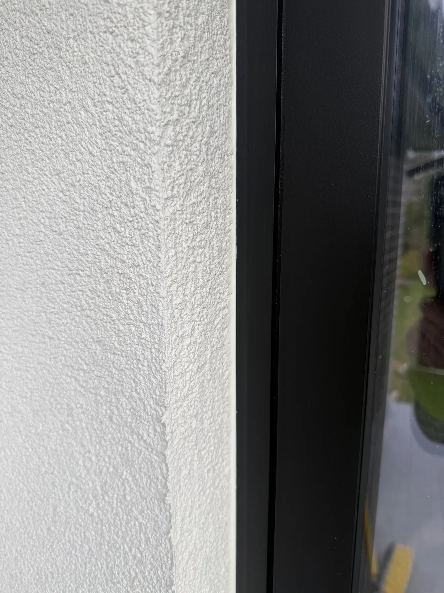 Stage 4e: Crisp Ecorend Marble White junction at aluminium window frame — Sandygate Sheffield by P&R Solutions