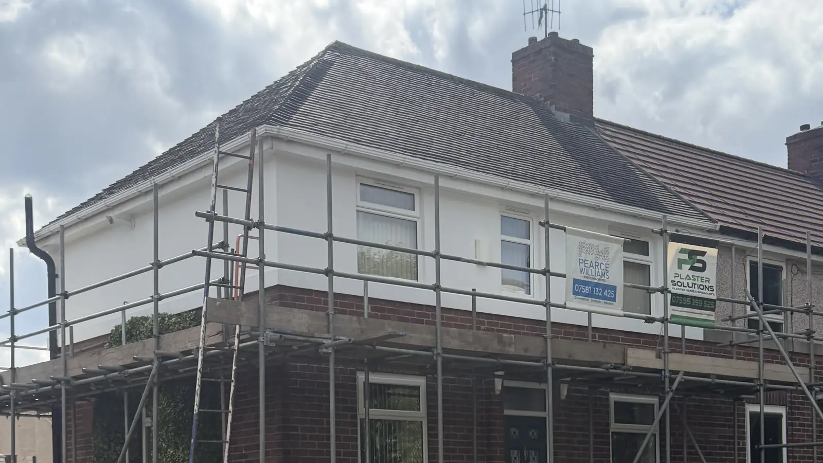 Semi-detached house on Crowder Avenue, Southey S5, with silicone render newly applied to the upper elevation and the brickwork below left exposed, scaffolding still in place